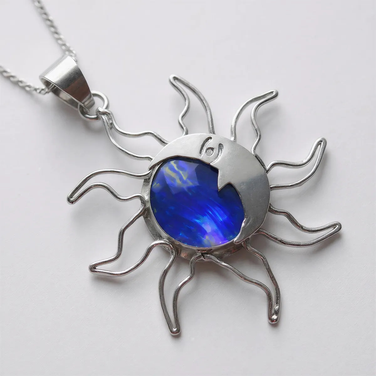 Artistic view Blue Fire pendant emphasizing infinite opal sparkles and sun power
