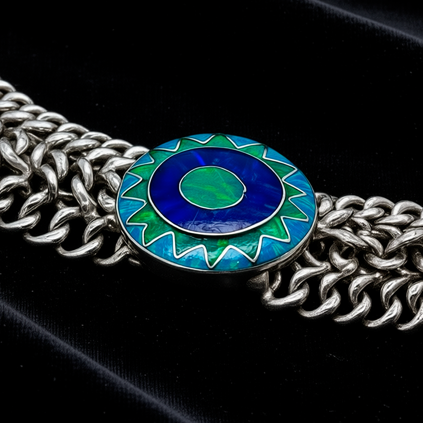 Close-up detail Emerald Sun showing hand-woven sterling silver links and artisanal craftsmanship