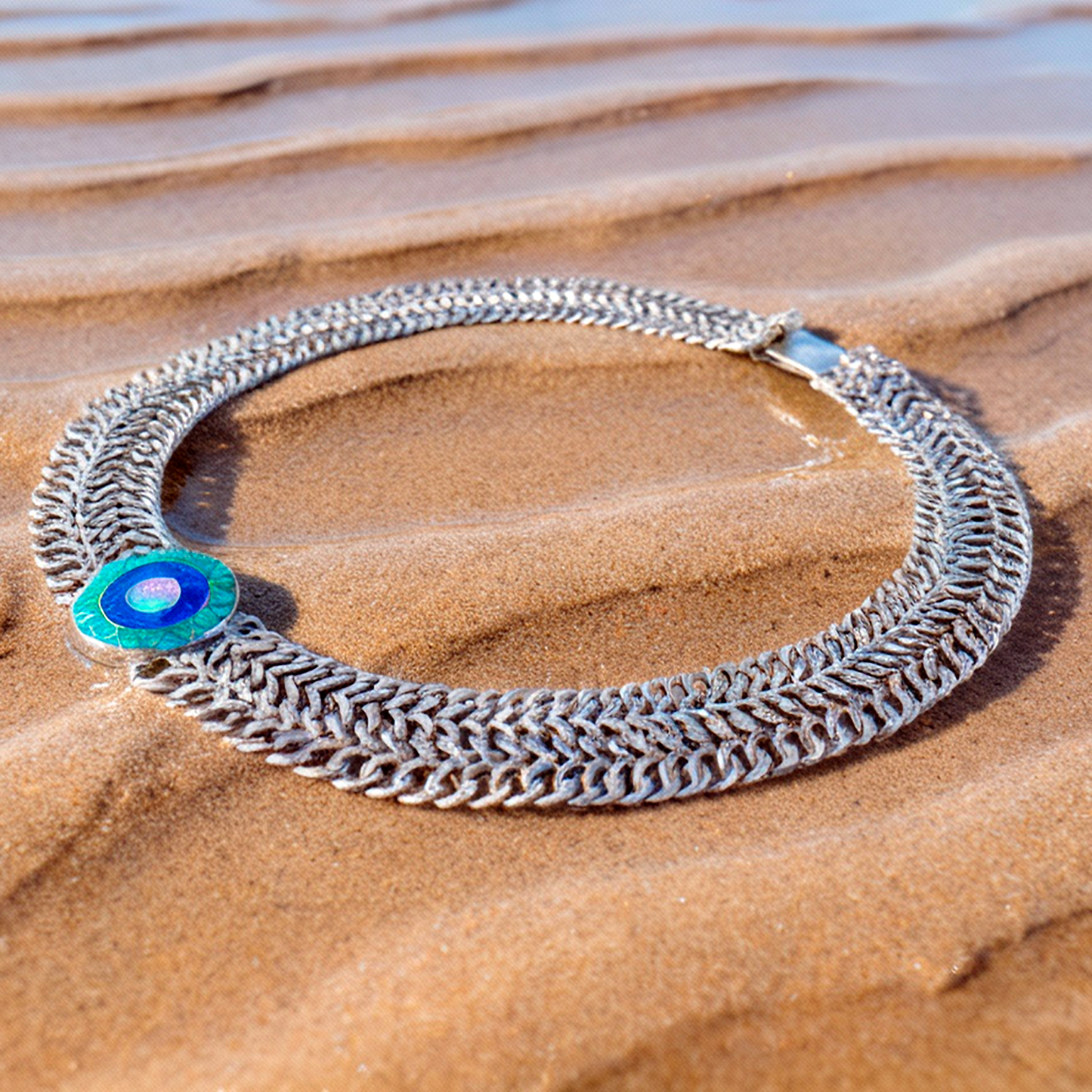 Detail macro Emerald Sun medallion highlighting opal color variations and sterling silver precision