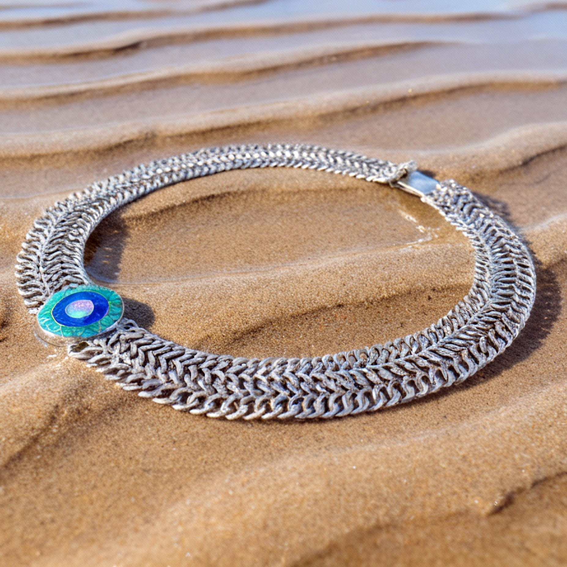 Detail macro Emerald Sun medallion highlighting opal color variations and sterling silver precision