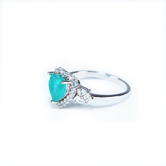 Heart of Gaia green tourmaline heart ring surrounded by cubic zirconia, front view