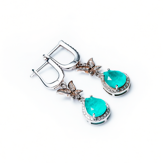 Metamorphosis rhodium silver earrings with green tourmaline drop and zircon halo, front view