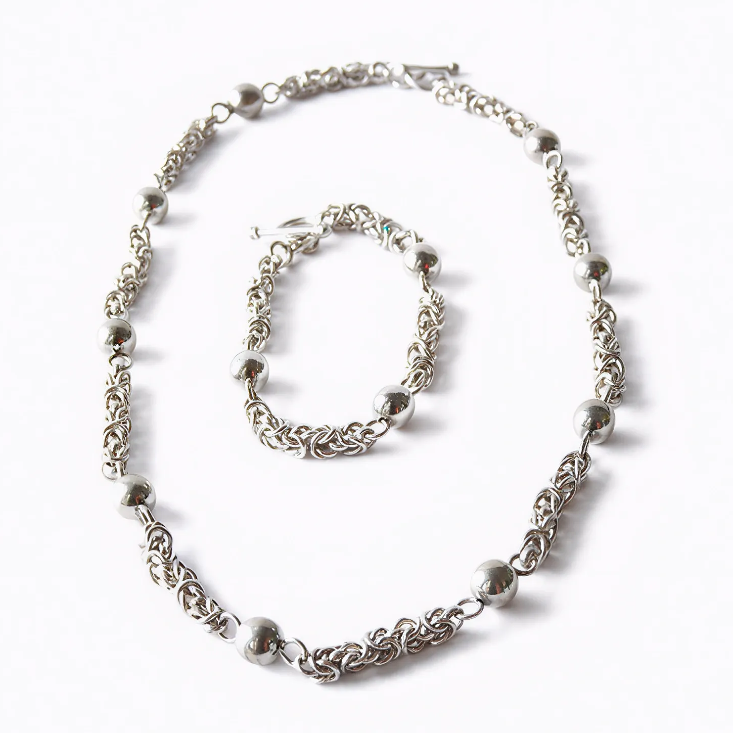 Moon Path silver necklace and bracelet set with spheres and delicate links, front view