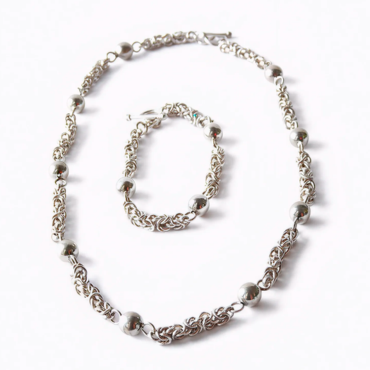 Moon Path silver necklace and bracelet set with spheres and delicate links, front view