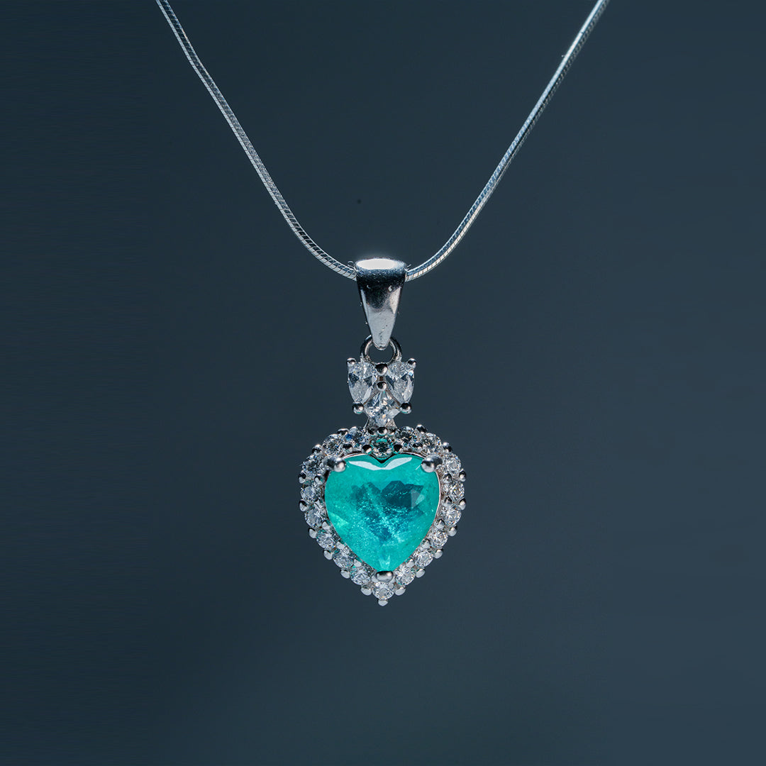 Side view Sacred Heartbeat pendant highlighting emerald hue and natural beauty