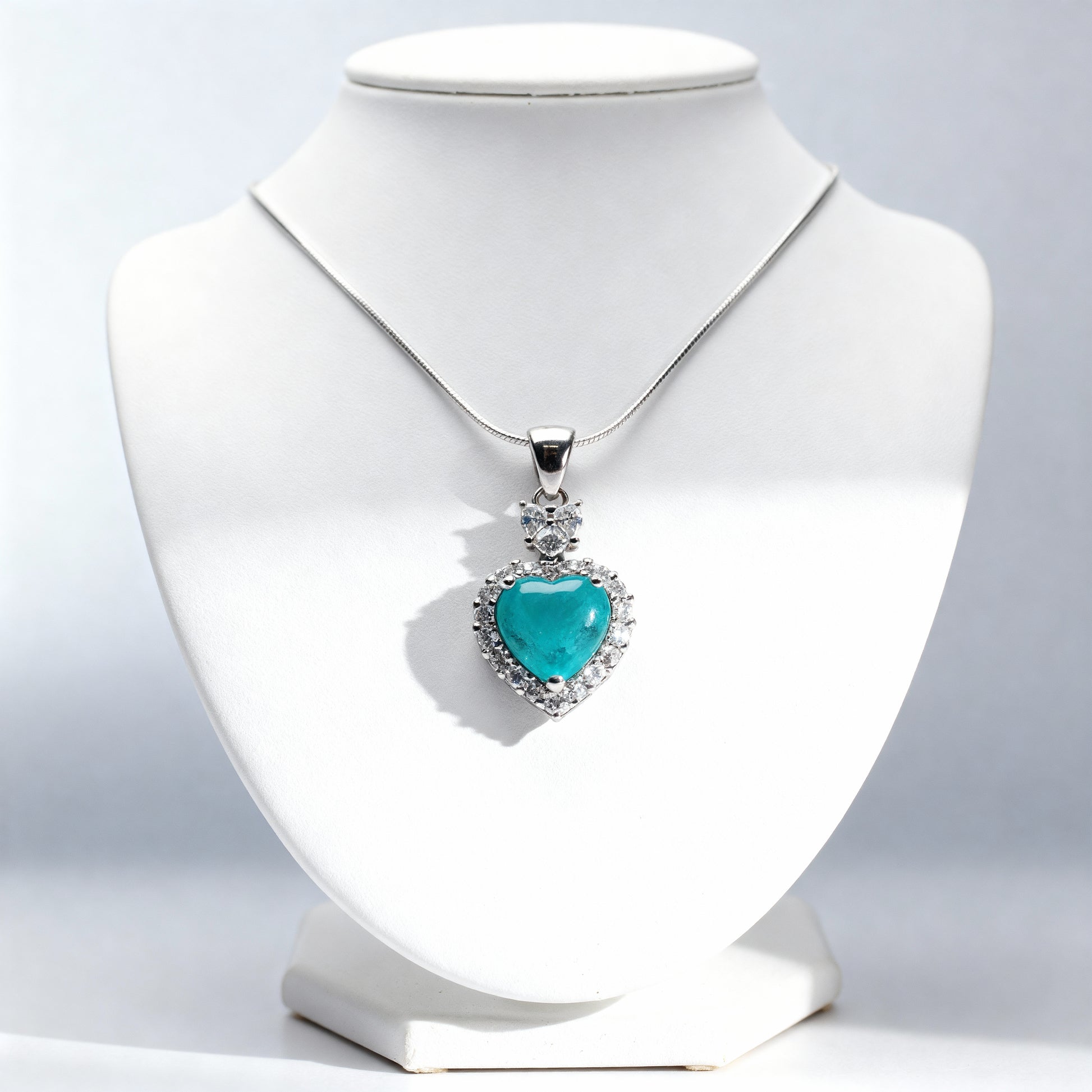 Close-up Sacred Heartbeat pendant displaying tourmaline brilliance and sophisticated design