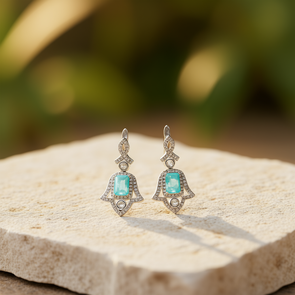 Wings of Protection earrings at angle showing Hamsa hand symbolism and contemporary design