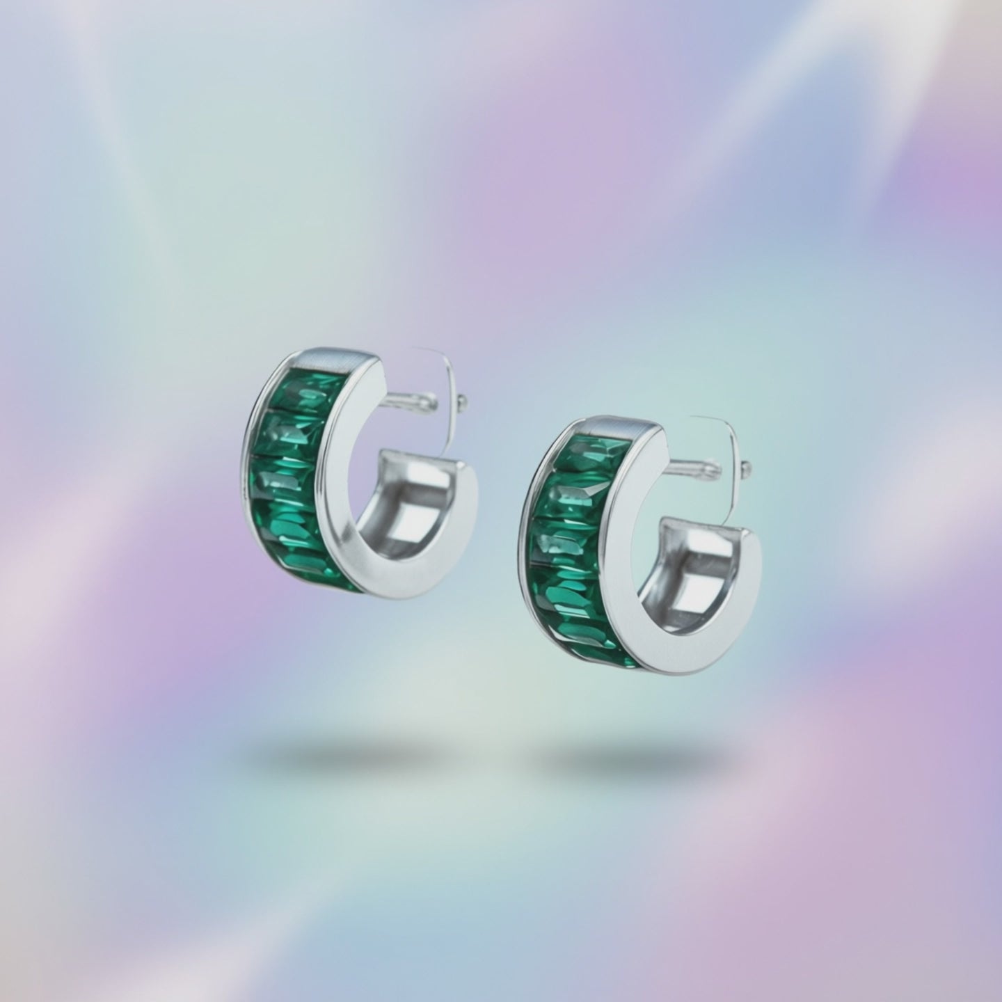 360-degree view of Green Essence hoop earrings showing rhodium silver finish and green cubic zirconia stones