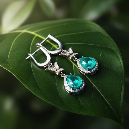 Metamorphosis earrings at angle displaying butterfly symbol and tourmaline sparkle