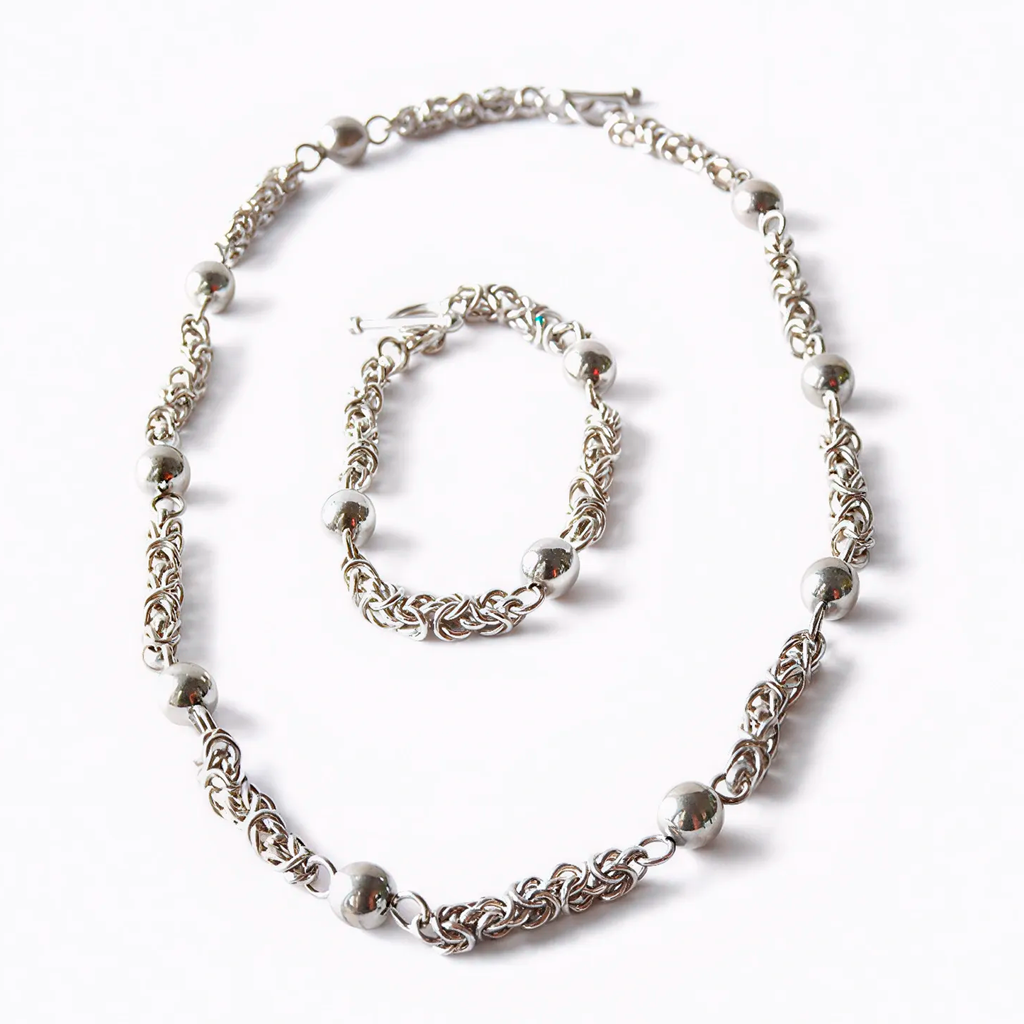 Moon Path silver necklace and bracelet set with spheres and delicate links, front view