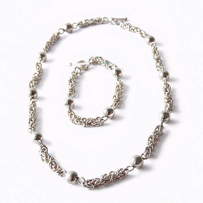 Moon Path silver necklace and bracelet set with spheres and delicate links, front view