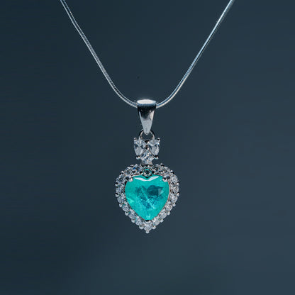Side view Sacred Heartbeat pendant highlighting emerald hue and natural beauty
